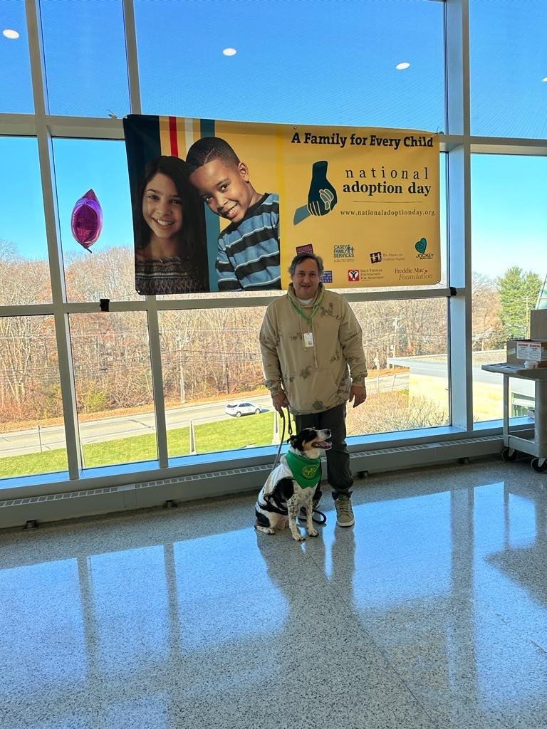 Carlos Moriella standing outdoors beside his dog